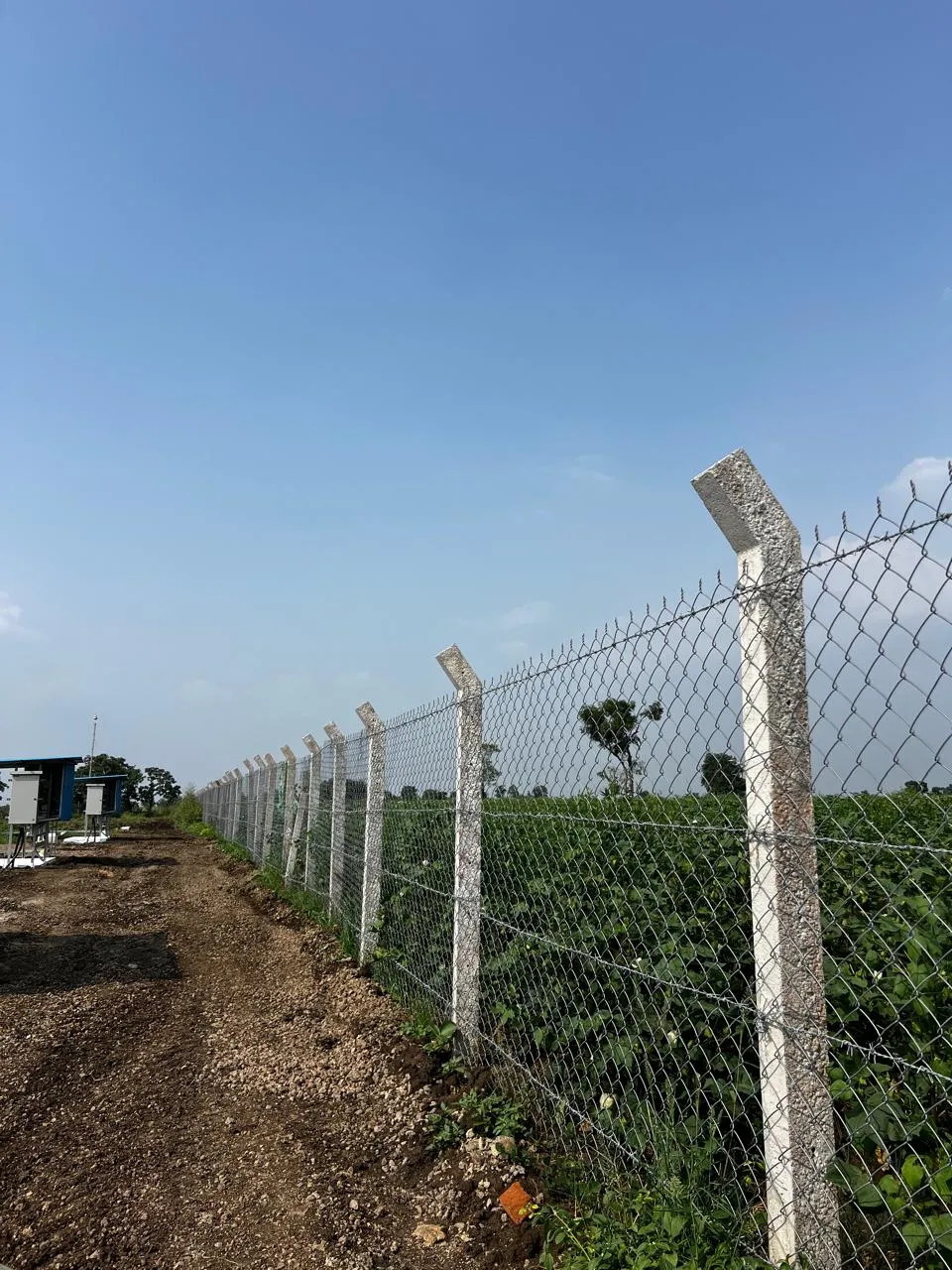 Chain link fencing on concrete posts with angled tops