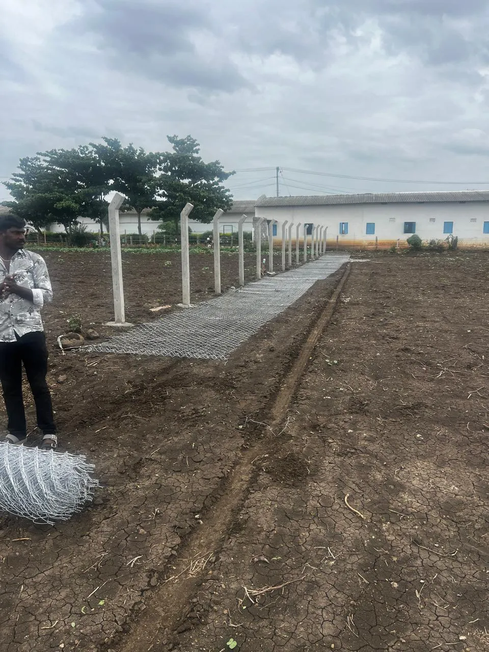 Chain link mesh laid out for installation on a new site