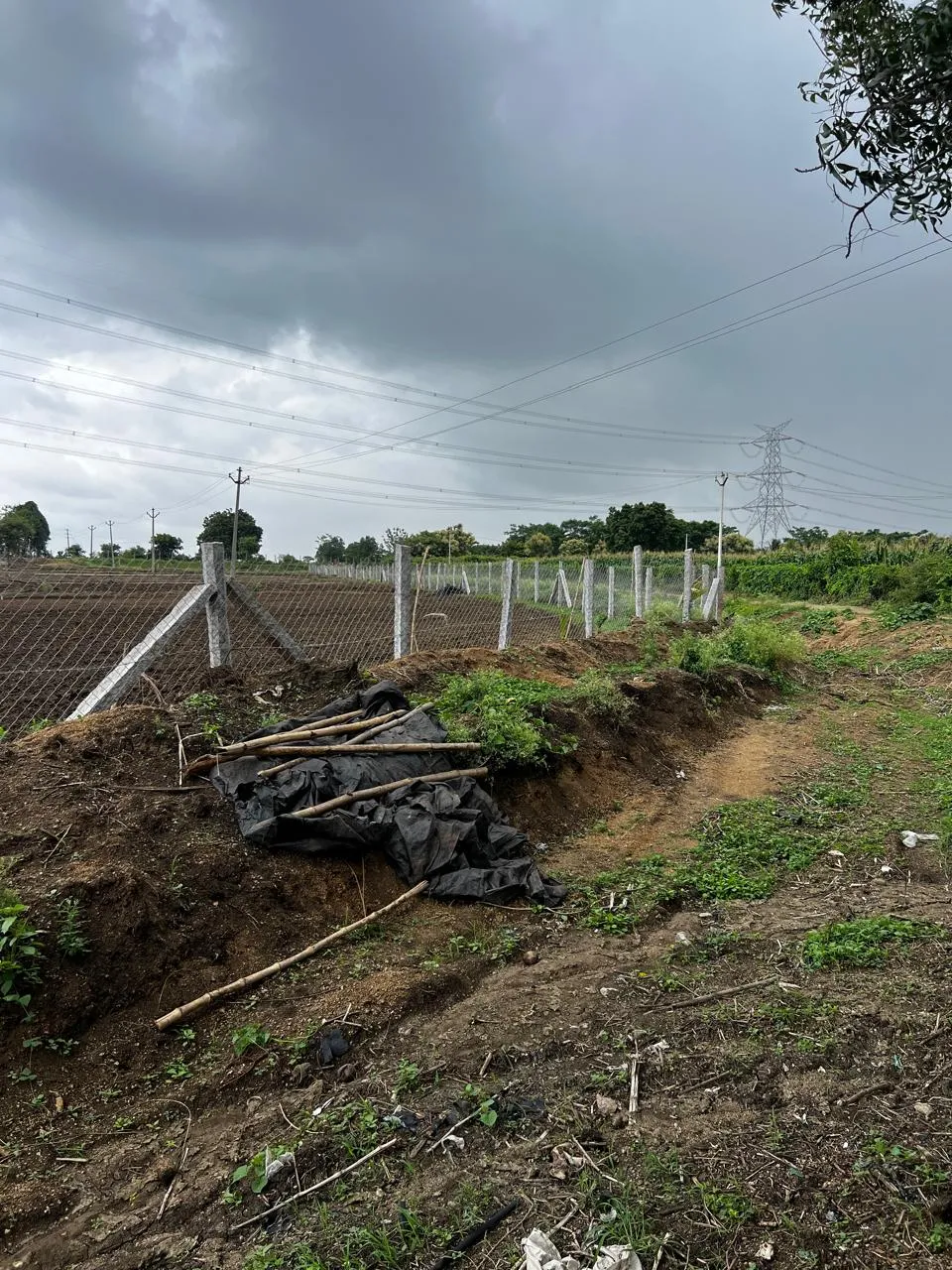 Chain link fencing going up along a field boundary
